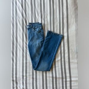 denim flared jeans with rips and frayed ends